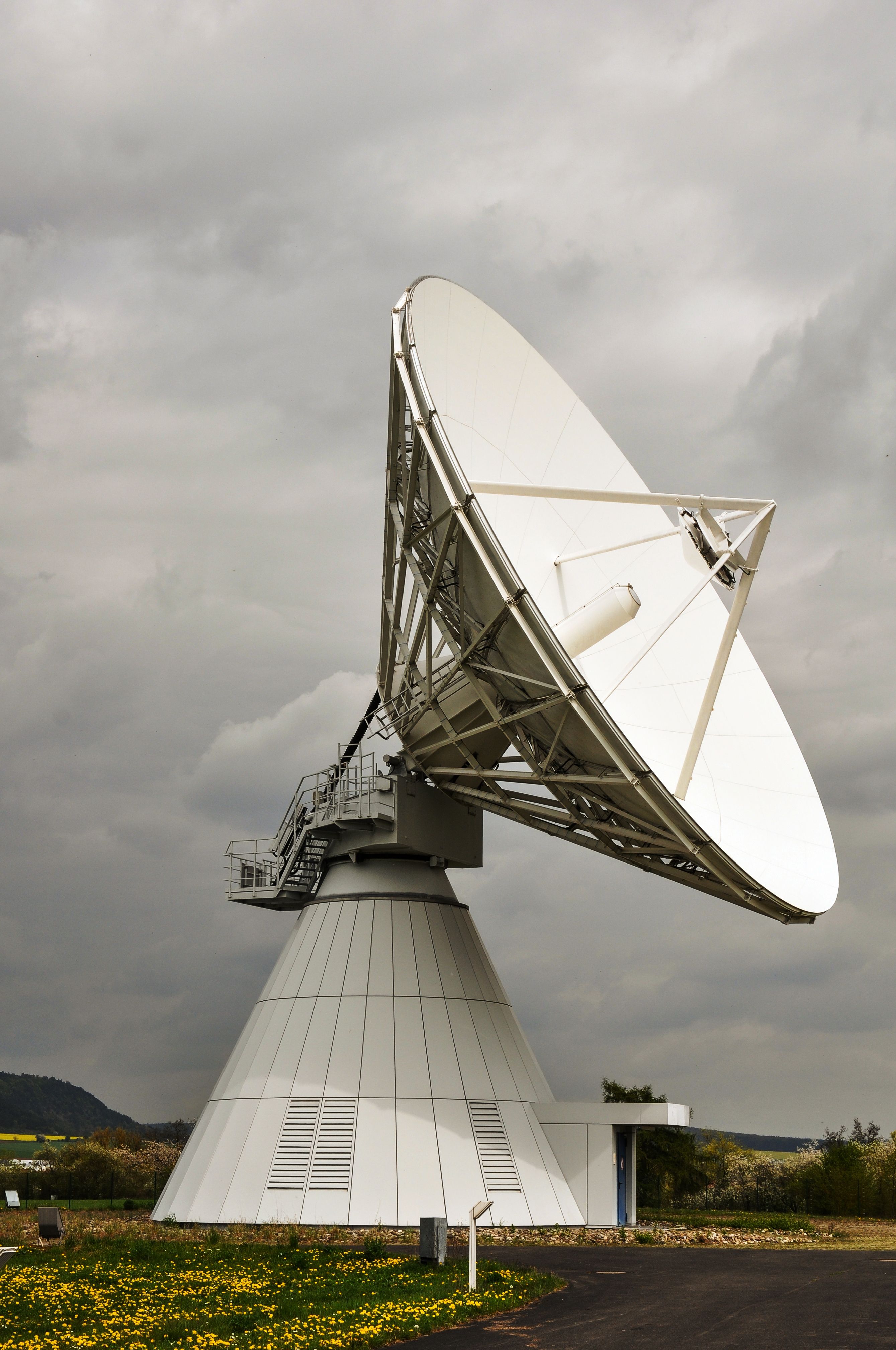 Large satellite dish beneath a cloudy sky